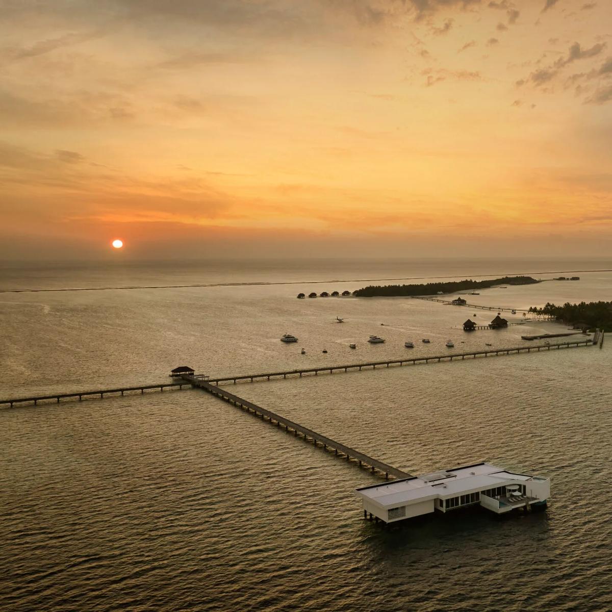 Aerial view of The Muraka at sunset, Conrad Maldives Rangali's undersea residence extending off Rangali Island on its own jetty