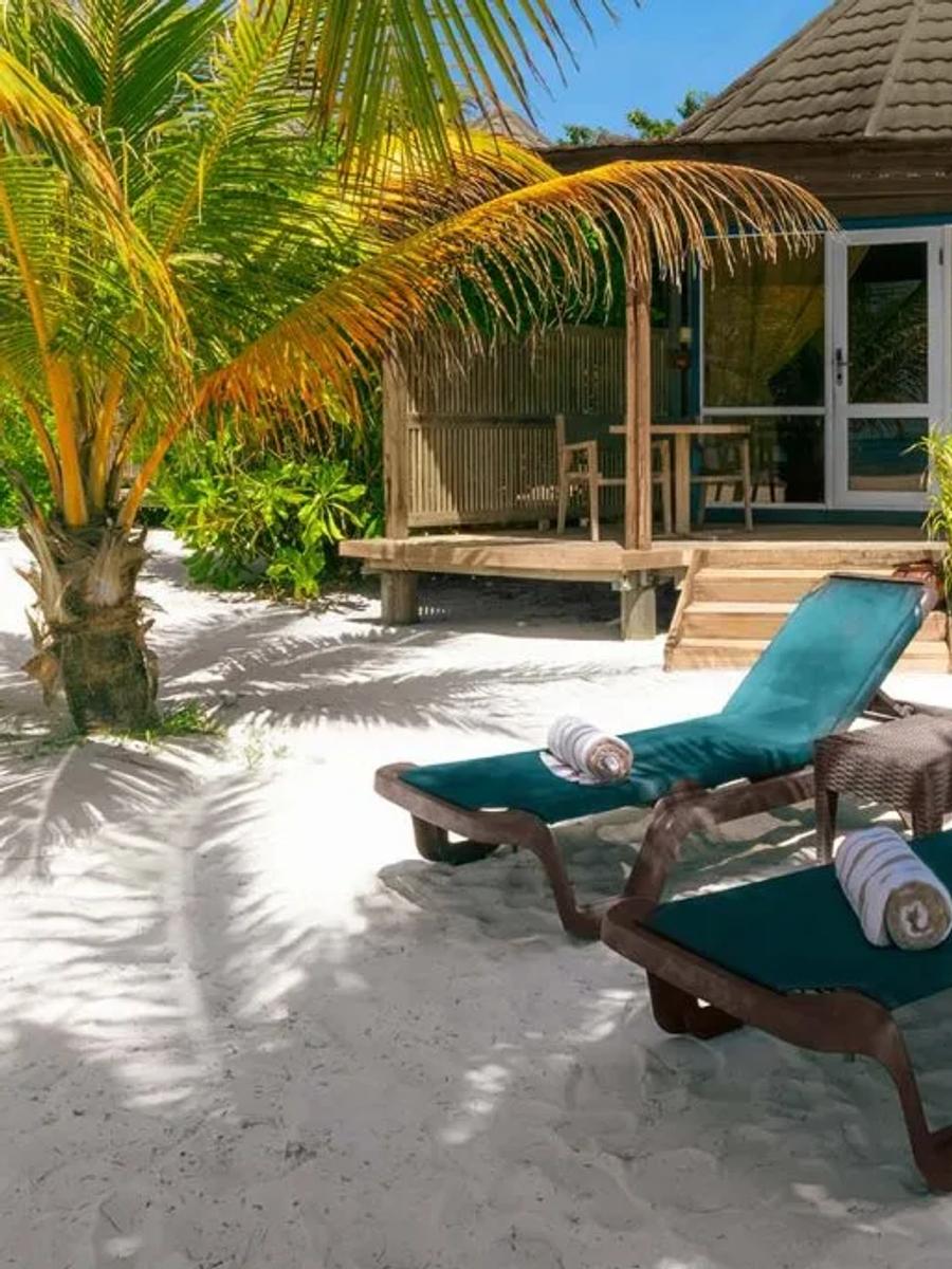 Sangu Premium Beach Villa bedroom with a corner window looking straight onto the ocean