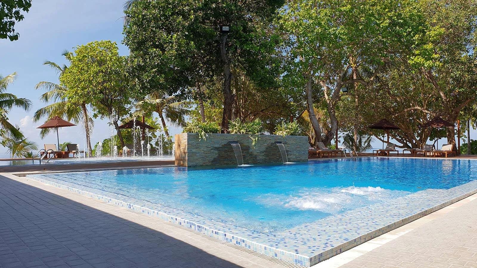 Sun loungers and umbrellas at Vibes, Lily Beach Resort & Spa's beachfront bar