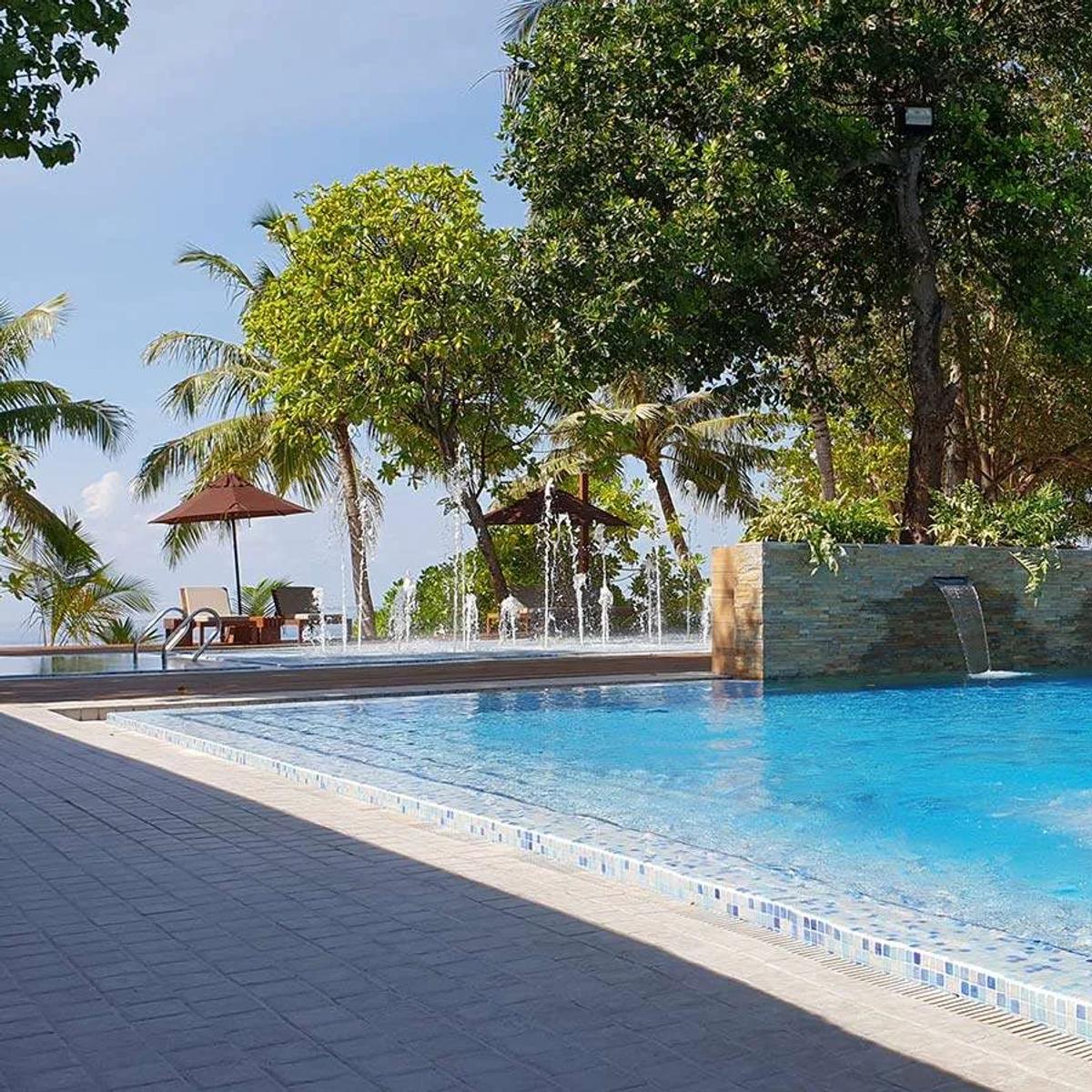 Sun loungers and umbrellas at Vibes, Lily Beach Resort & Spa's beachfront bar