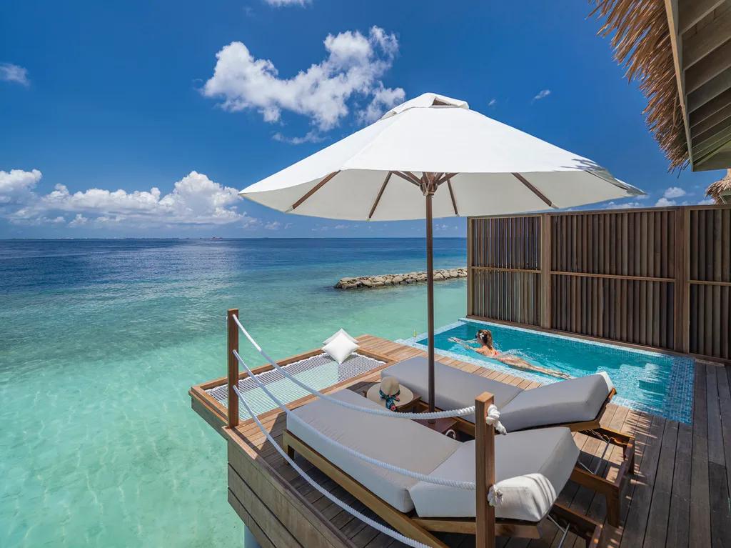 The private plunge pool and sun deck of a Sunset Water Villa with Pool, built out over the clear lagoon at Bandos