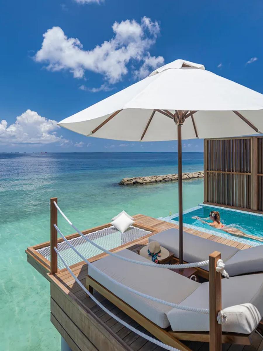 The private plunge pool and sun deck of a Sunset Water Villa with Pool, built out over the clear lagoon at Bandos