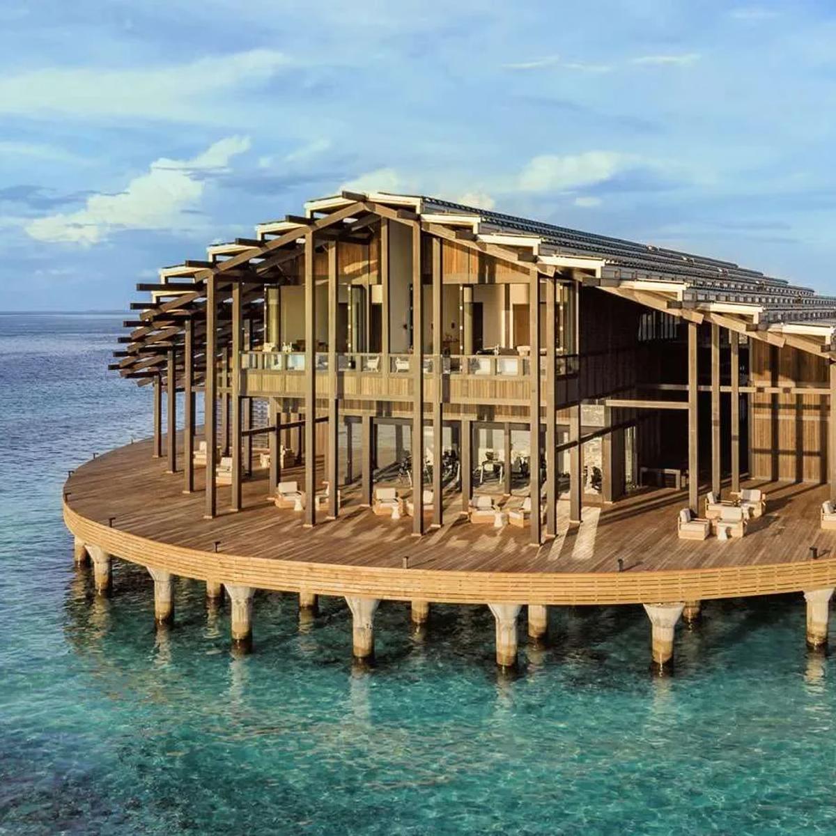 The Retreat, Kudadoo's two-storey main building, raised on stilts over the lagoon with its solar-panelled roof