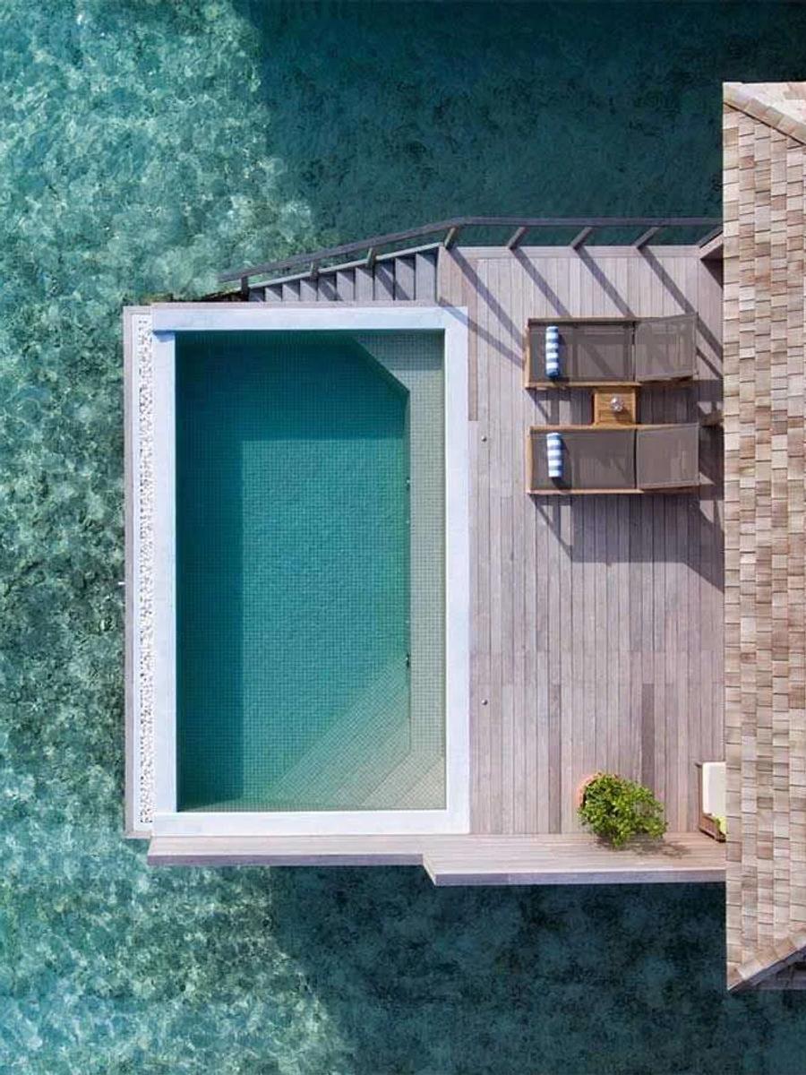 An Ocean Pool Villa's infinity pool seen from directly above, its far edge meeting the turquoise lagoon