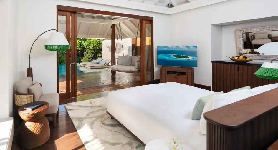 Bedroom of a Beach Pool Villa opening onto its private pool at Anantara Kihavah
