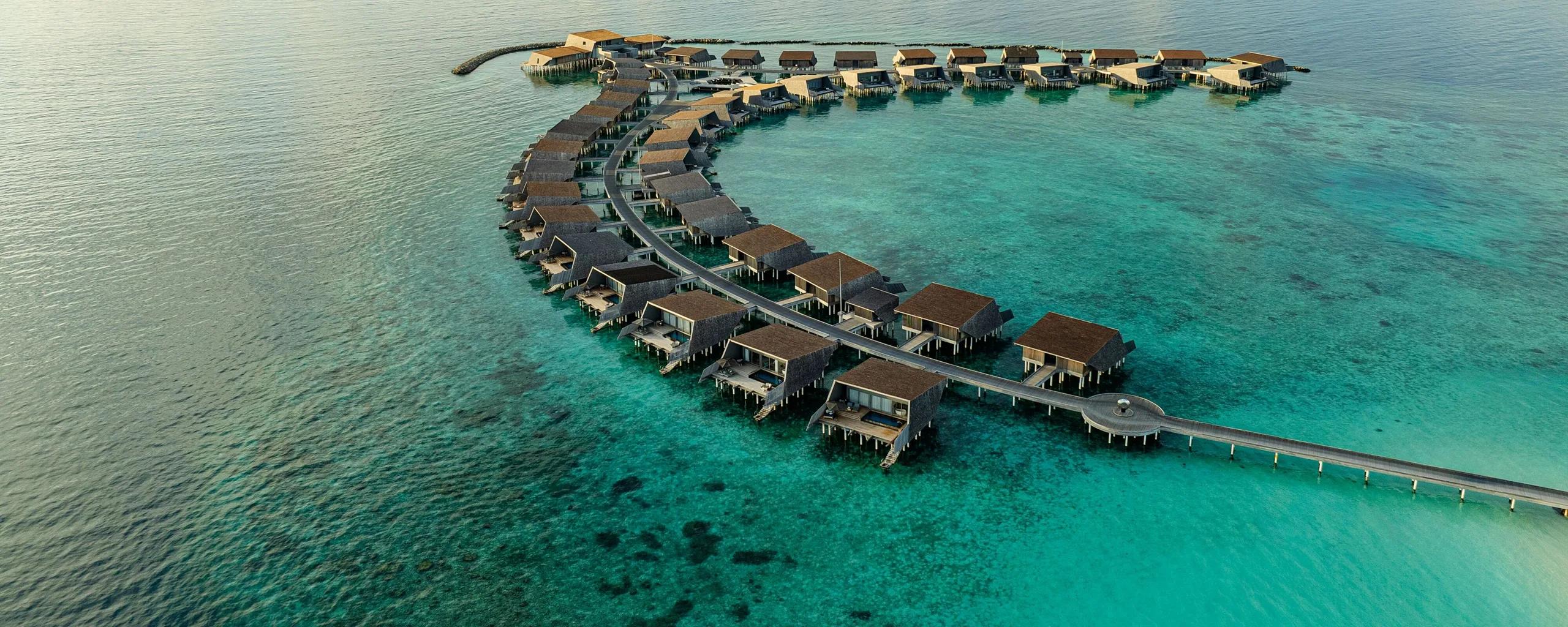 An Overwater Villa's terrace suspended above the turquoise lagoon at The St. Regis Maldives Vommuli Resort
