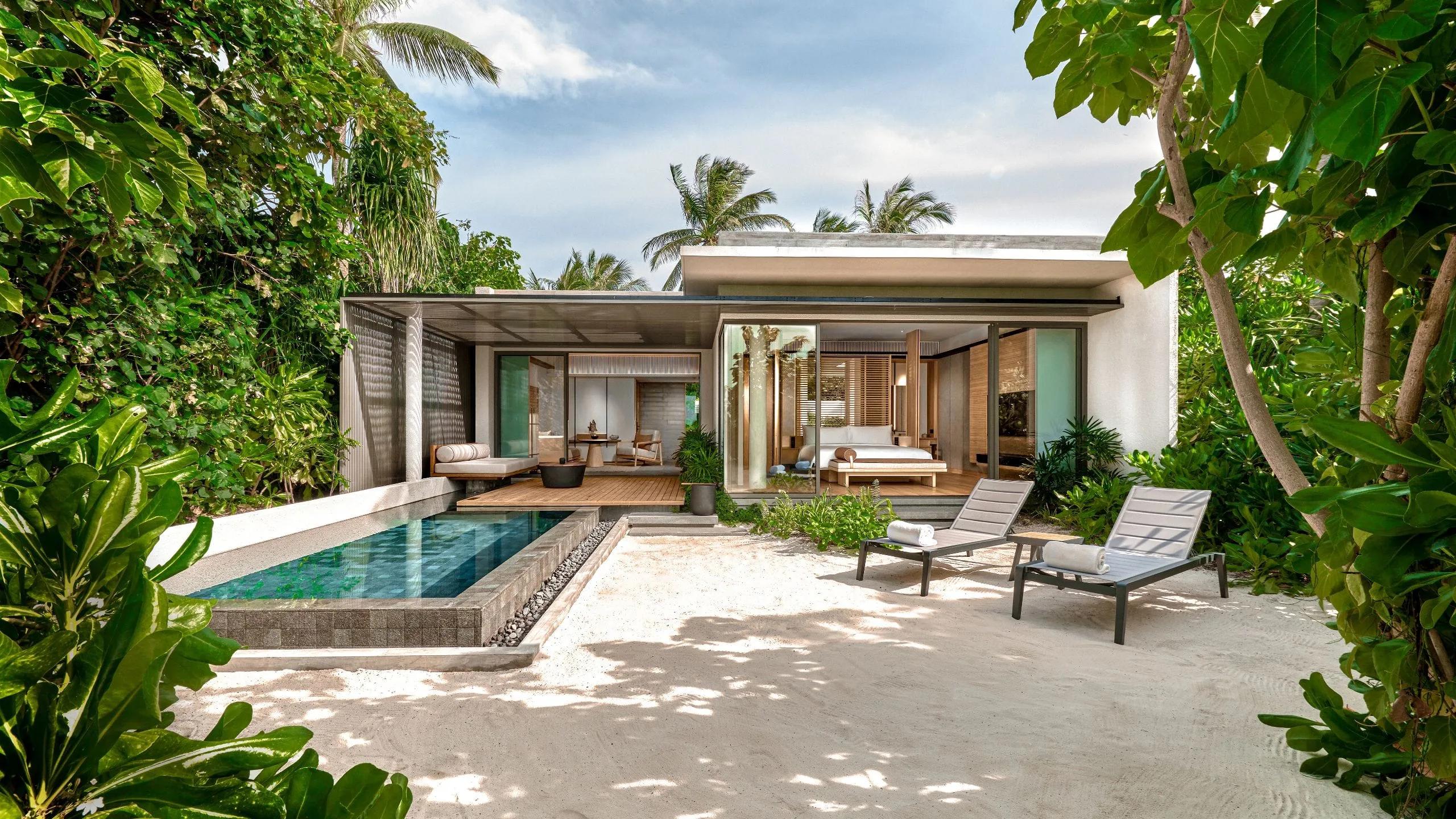 A Beach Villa's exterior and private pool, seen across the lawn