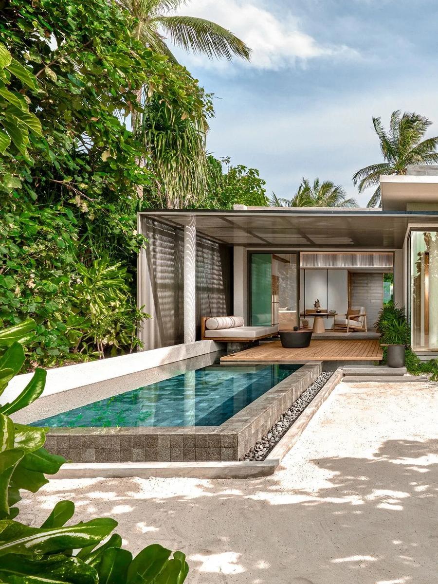 A Beach Villa's exterior and private pool, seen across the lawn