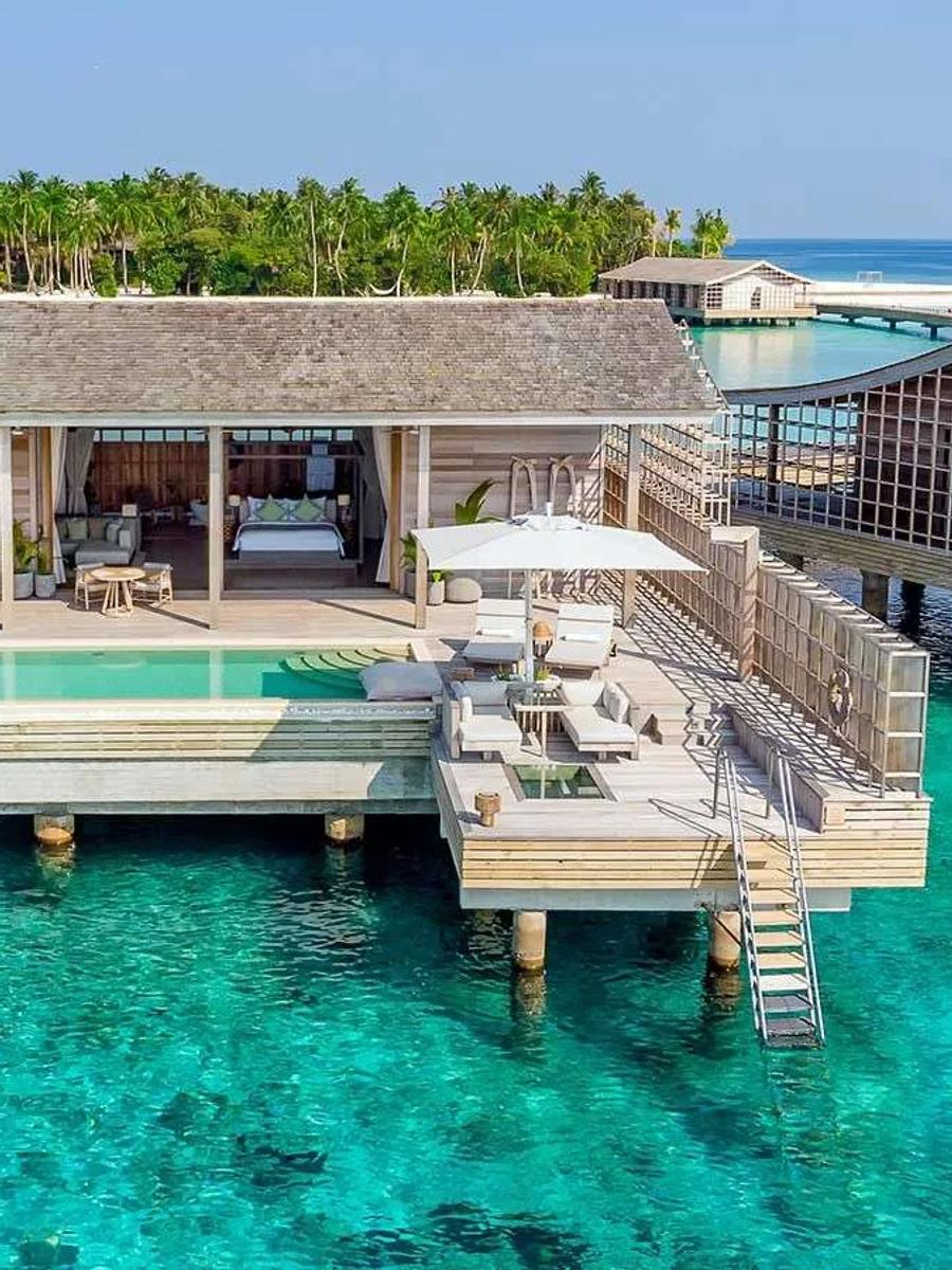 An Ocean Residence's overwater deck and 44-square-metre infinity pool, with Kudadoo's palm canopy behind