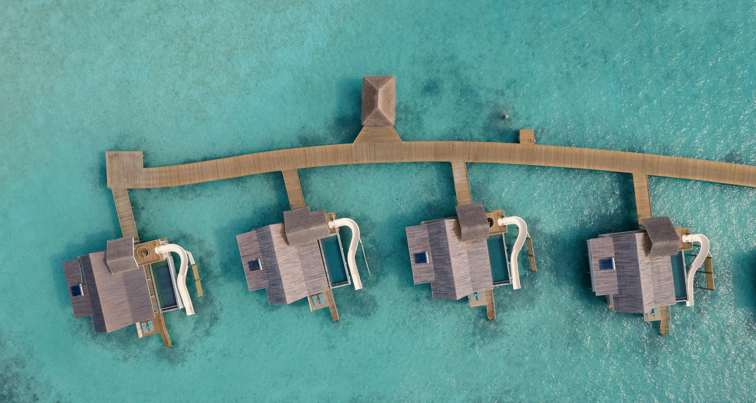 A Water Pool Villa with Slide at RAH GILI Maldives, overwater with its signature curved waterslide