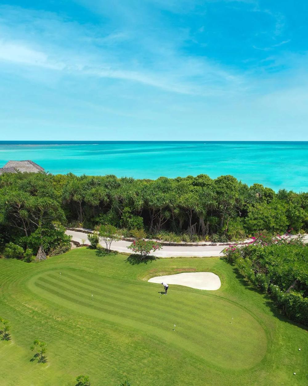 A golfer putting on the green at Hideaway Golf Center, Maldives