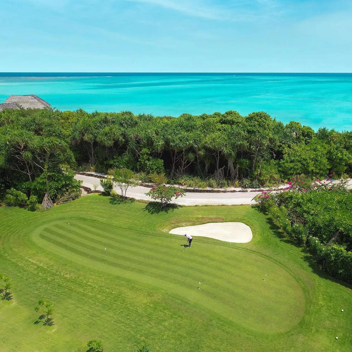 A golfer putting on the green at Hideaway Golf Center, Maldives