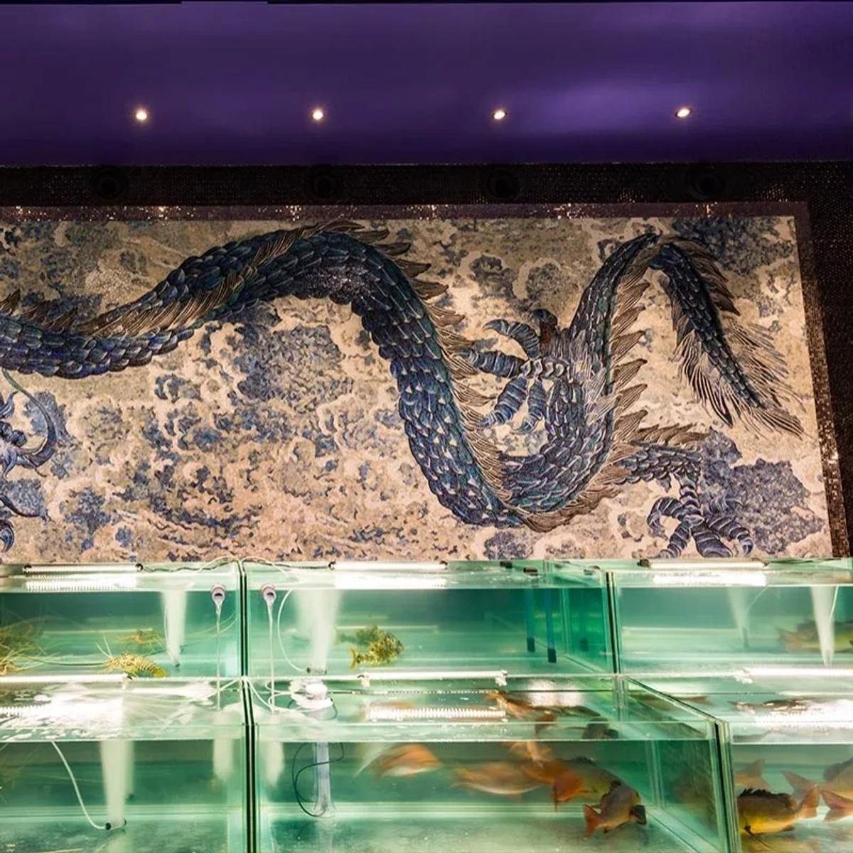 Sea Dragon's mosaic dragon wall above its live seafood display tanks
