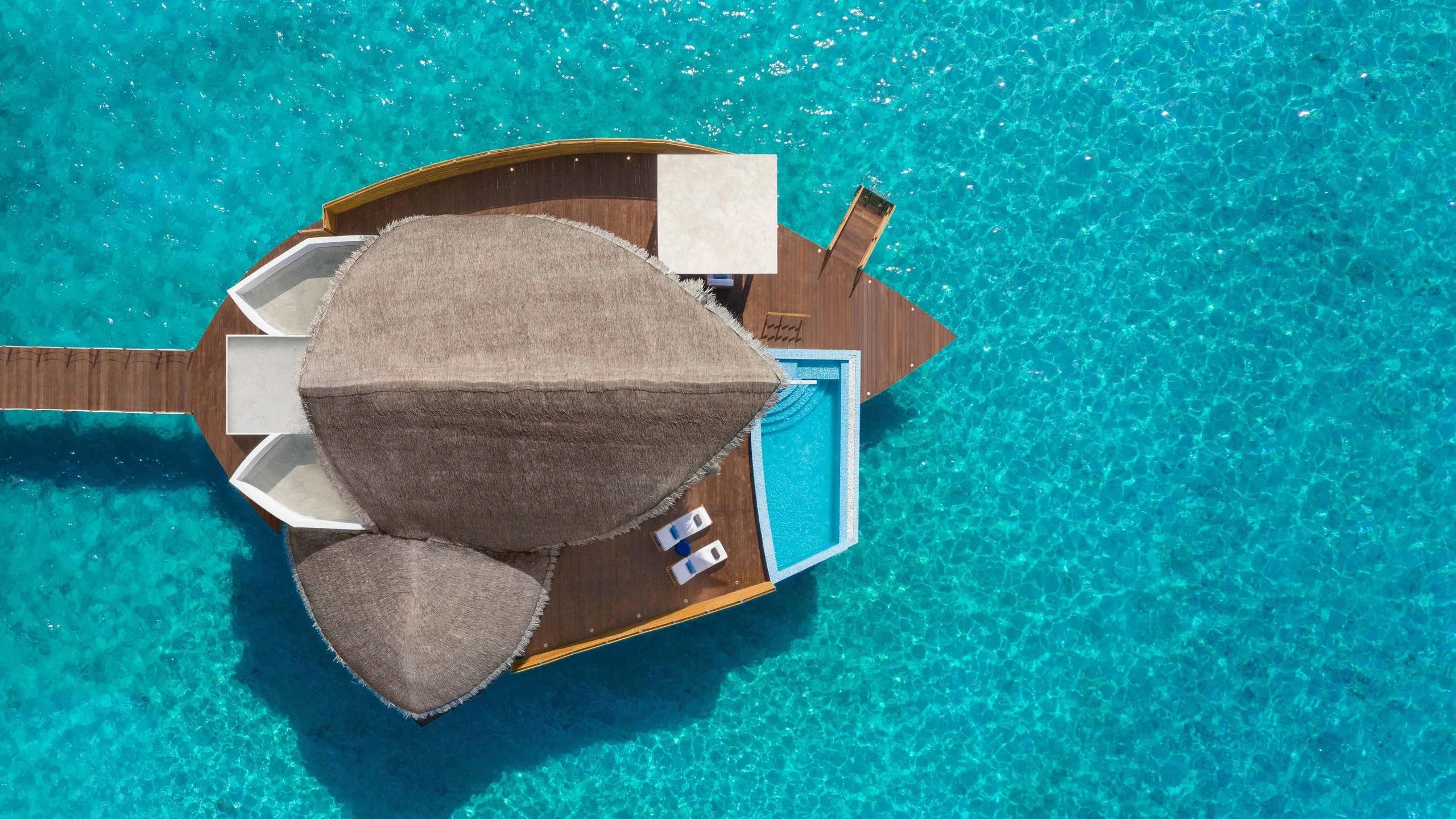 Top-down aerial view of a Duplex Overwater Pool Villa and its private pool, set in the turquoise lagoon