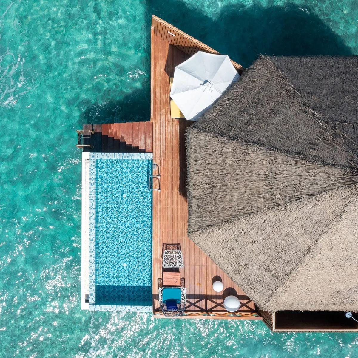 An aerial view of the private pool and deck of an overwater villa at Mercure Maldives Kooddoo Resort, Gaafu Alifu Atoll