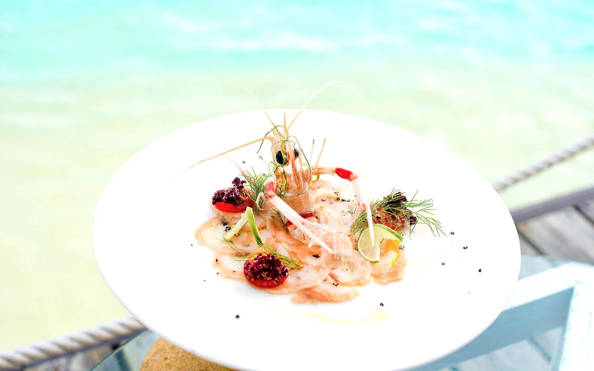 A carpaccio-style seafood plate garnished with prawn and citrus, served at the Kakuni Sea Food Dining Experience