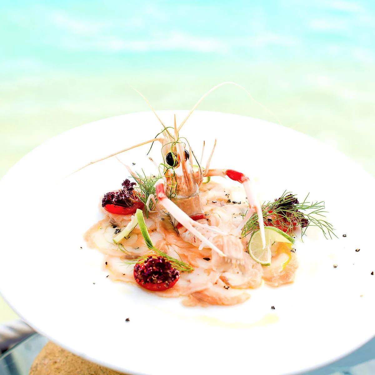 A carpaccio-style seafood plate garnished with prawn and citrus, served at the Kakuni Sea Food Dining Experience