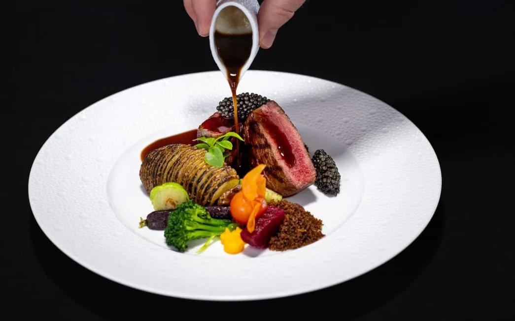 A plated course served at SEA, the underwater restaurant at Anantara Kihavah Maldives Villas