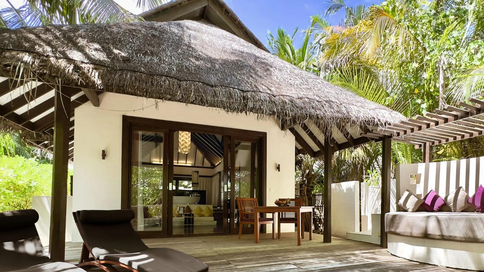 Private plunge pool of a Beach Villa with Pool, black-tiled accent wall and outdoor pergola