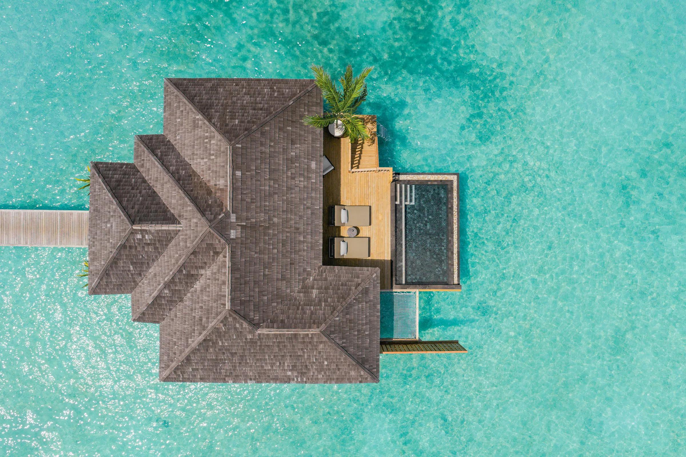 Aerial view of an overwater Water Villa with Pool, its private pool and sundeck built out over the lagoon