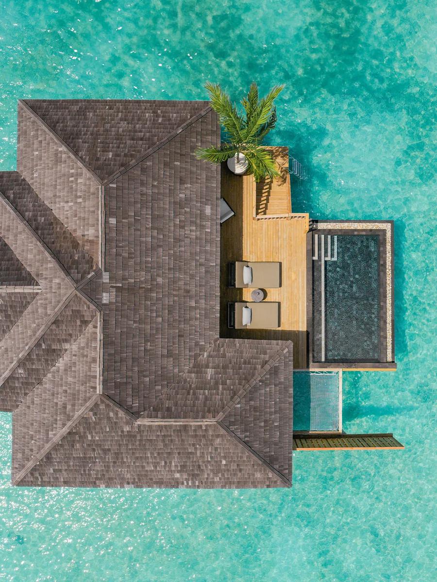 Aerial view of an overwater Water Villa with Pool, its private pool and sundeck built out over the lagoon