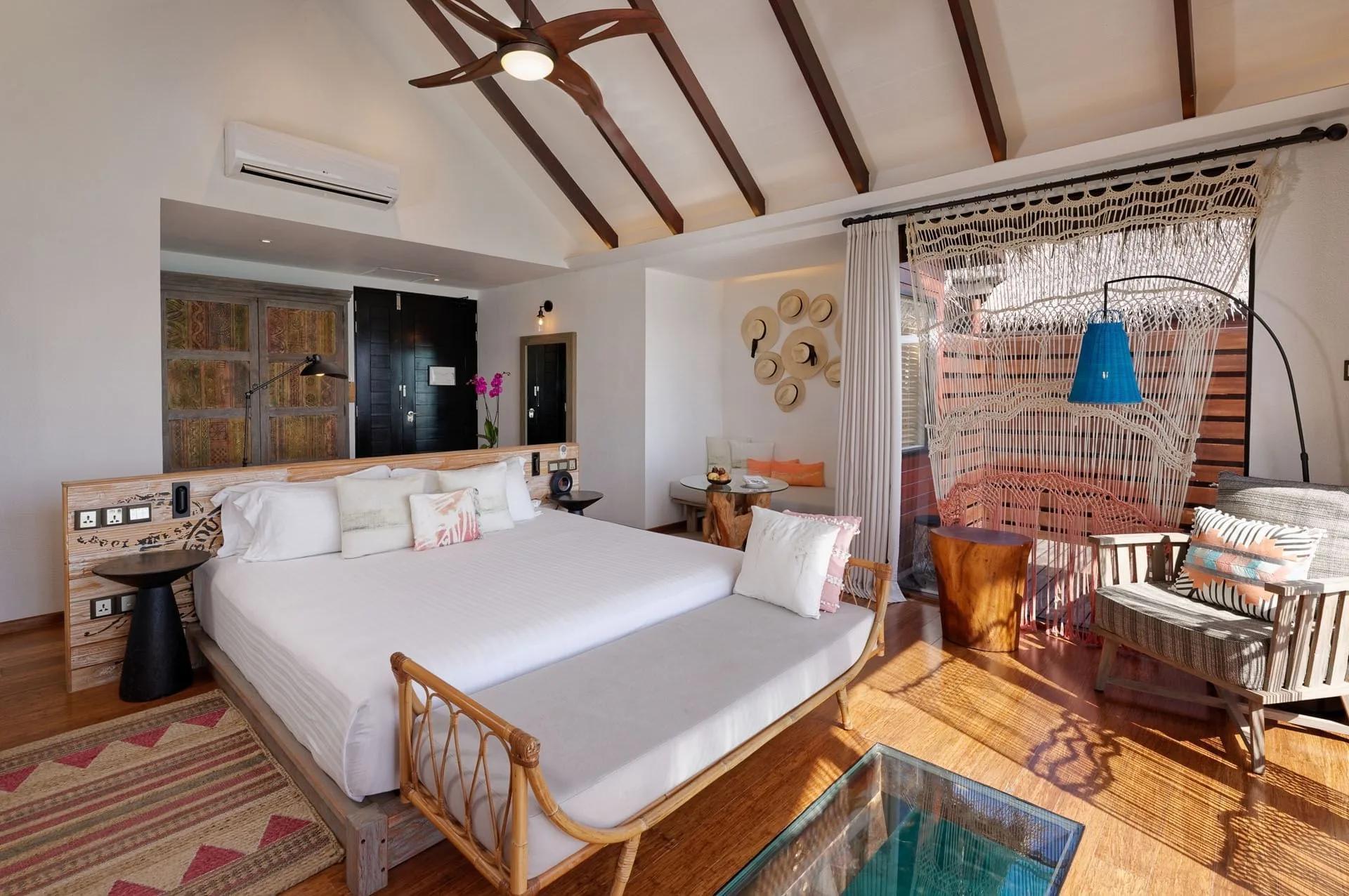 The bedroom of an Ocean Water Villa