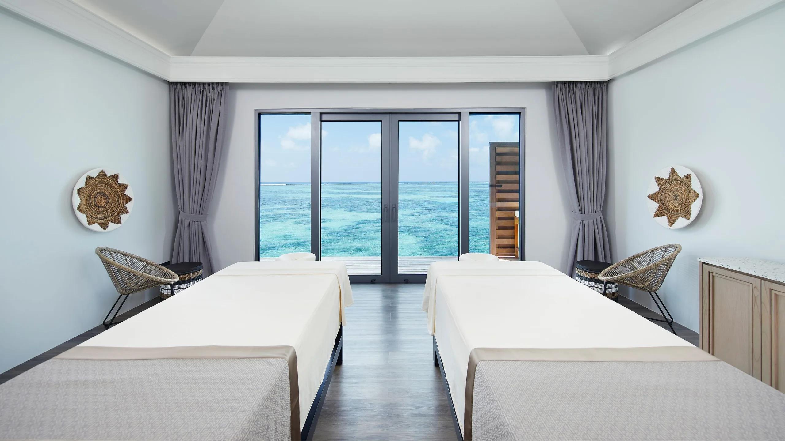 A double treatment room at Explore Spa, opening onto a private deck over the lagoon