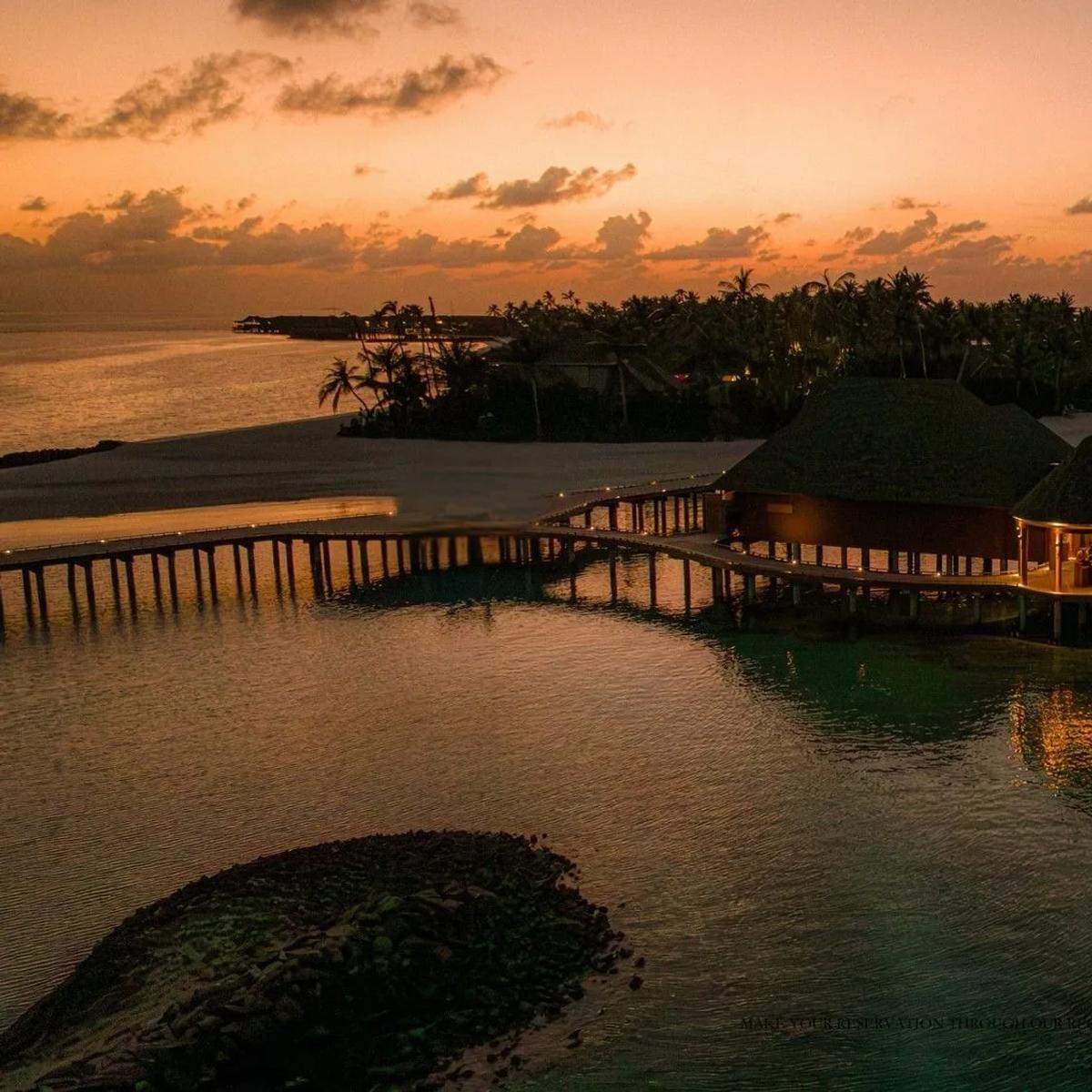 Luna's overwater dining hall at dusk, set between ananea Madivaru's two islands
