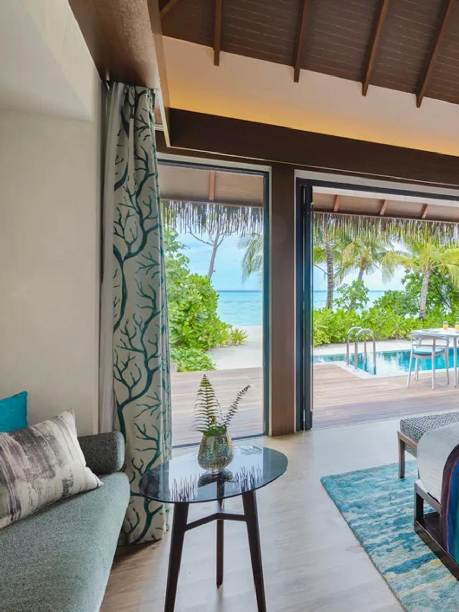 The private pool and terrace of a Beach Pool Villa surrounded by vegetation