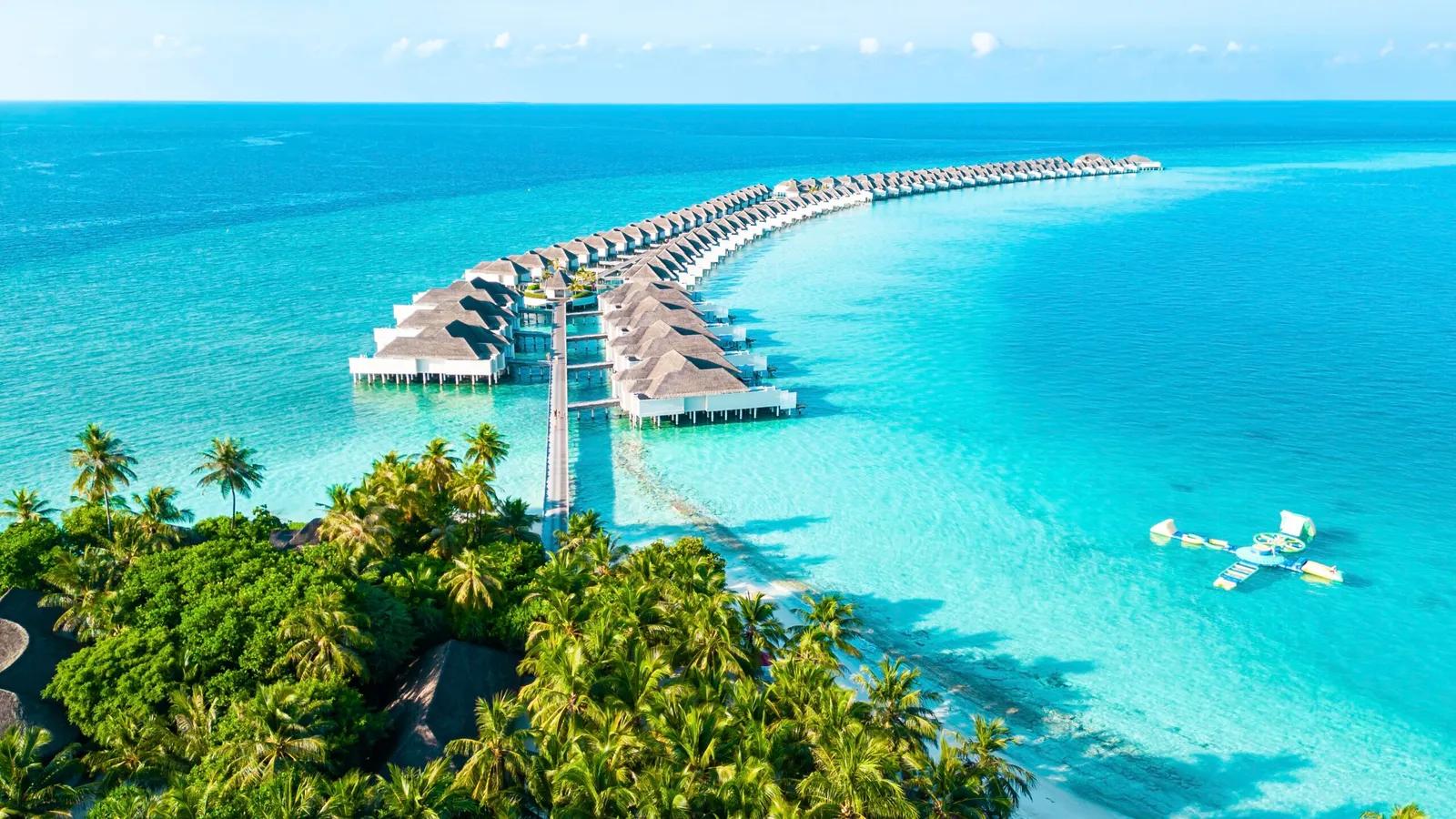 A Maldives resort island and its long sandbank from the air