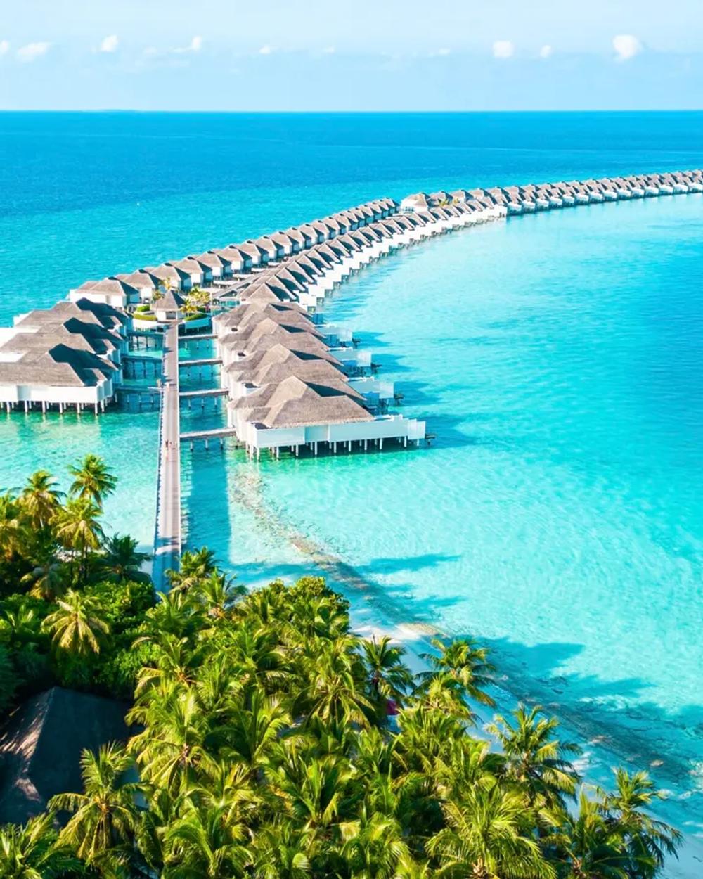 A Maldives resort island and its long sandbank from the air