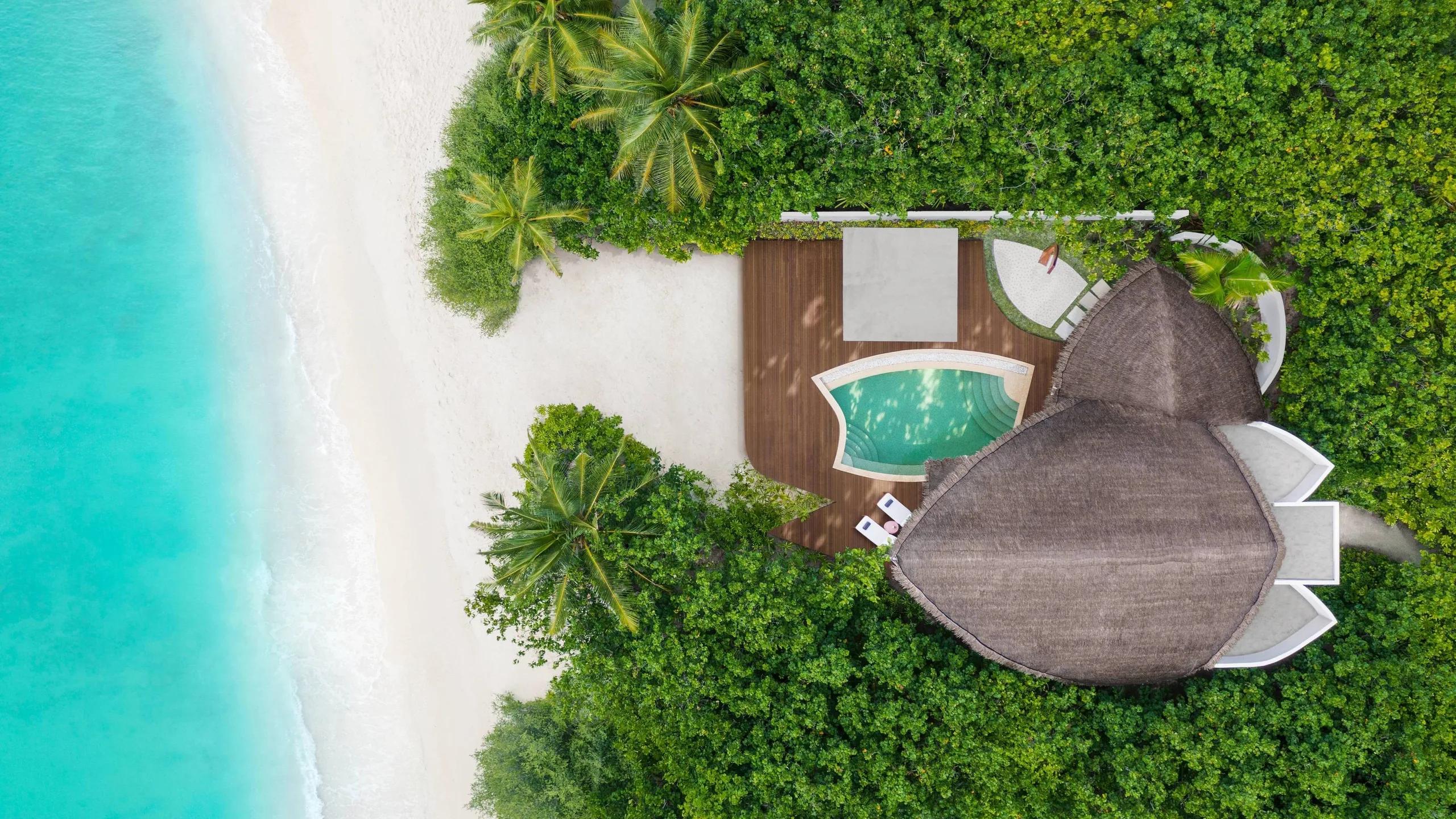 Top-down aerial view of a Beach Pool Villa's pool deck, steps from the beach