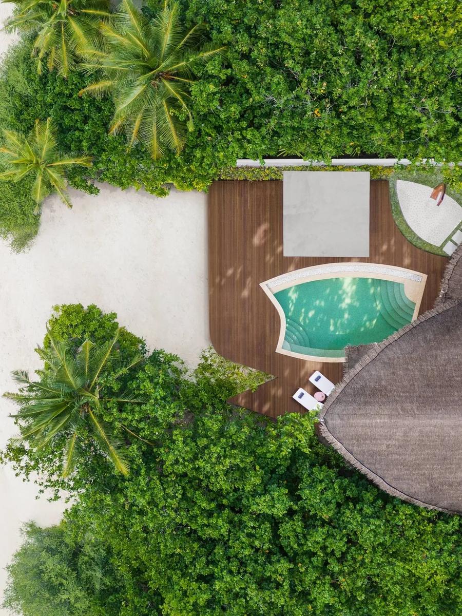 Top-down aerial view of a Beach Pool Villa's pool deck, steps from the beach