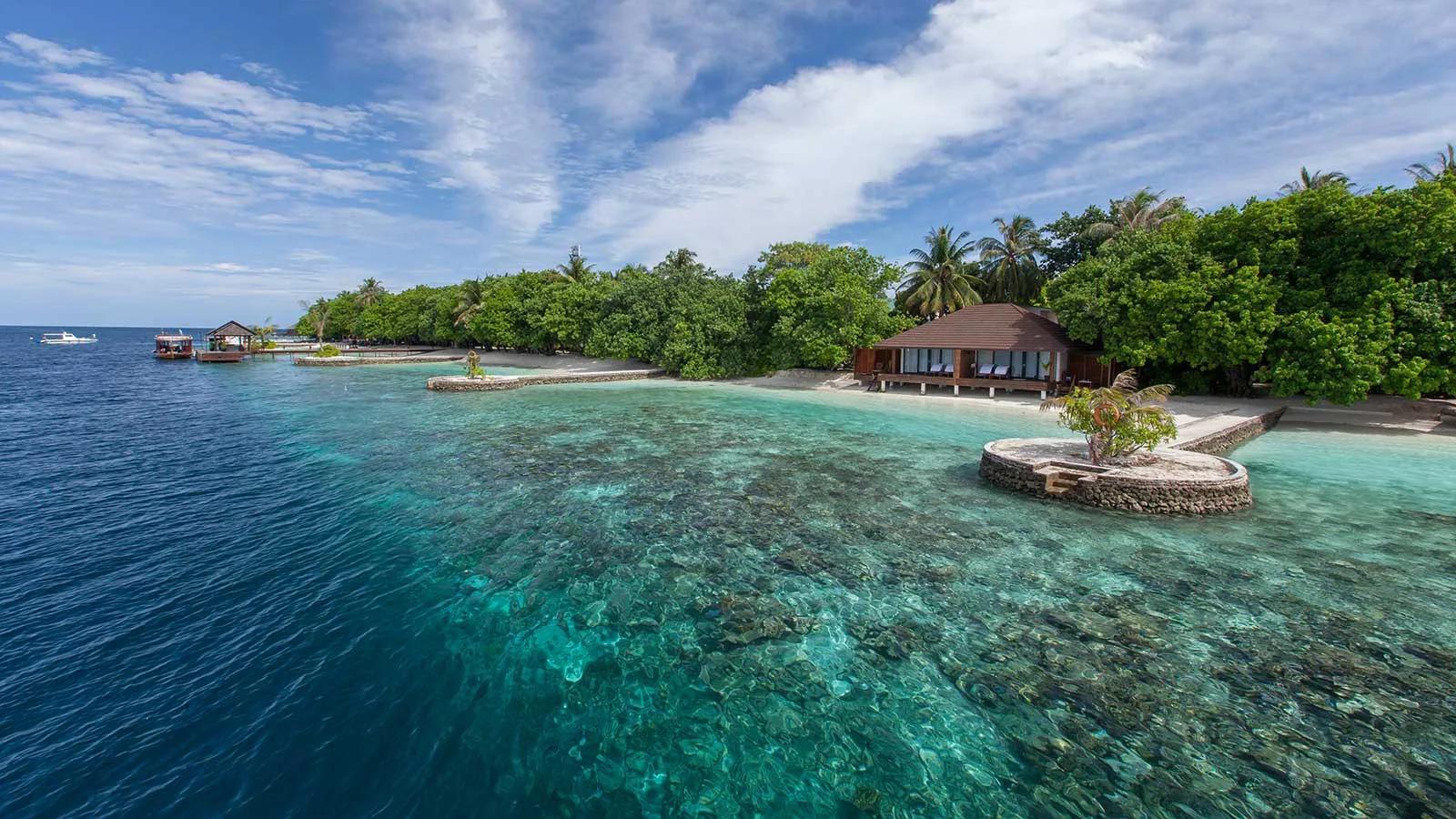 A Lagoon Villa's terrace opening directly onto the reef at Lily Beach Resort & Spa