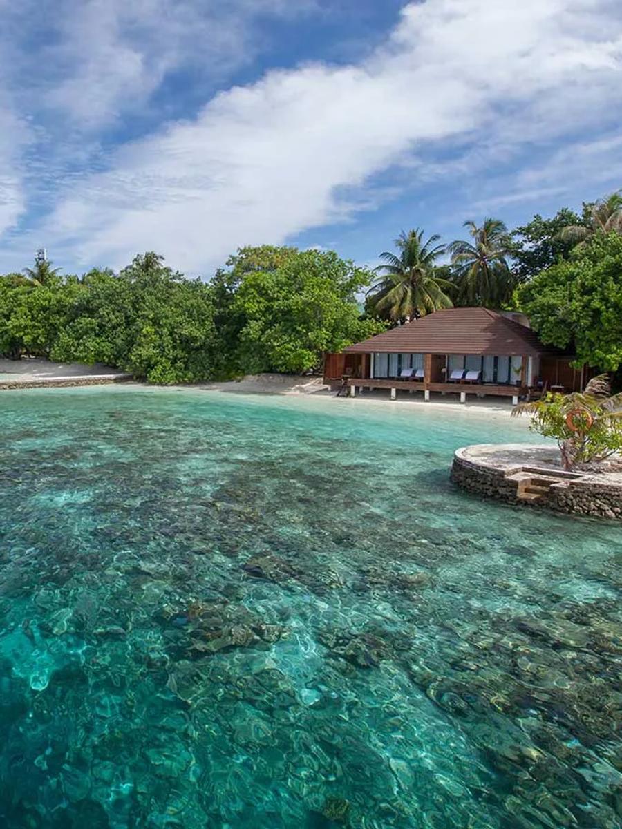 A Lagoon Villa's terrace opening directly onto the reef at Lily Beach Resort & Spa