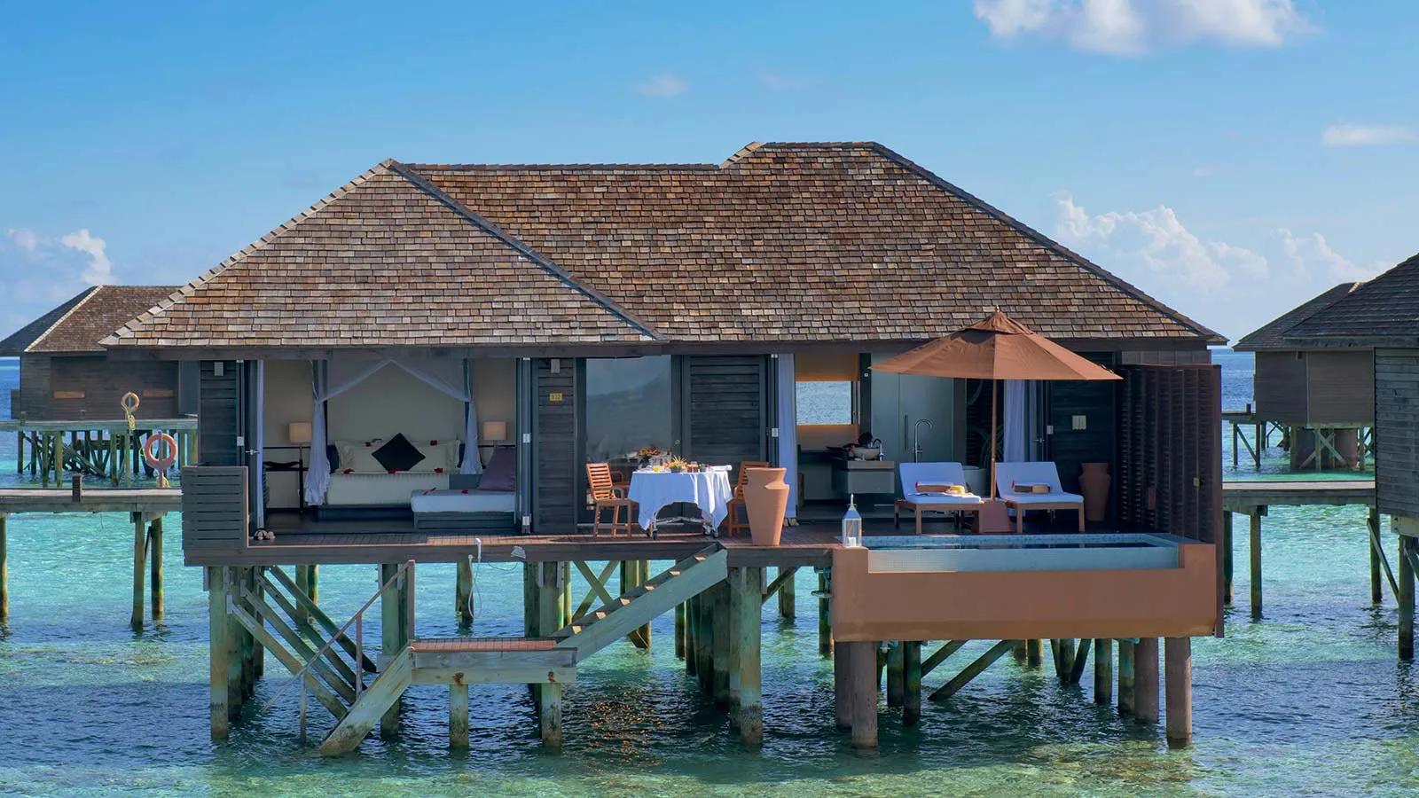 A Deluxe Water Villa's overwater deck at Lily Beach Resort & Spa, steps down to the lagoon