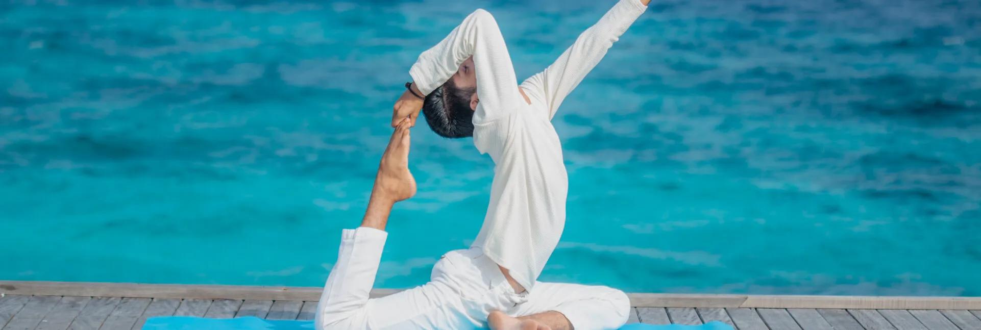 A yoga session on a wellness terrace at JA Manafaru