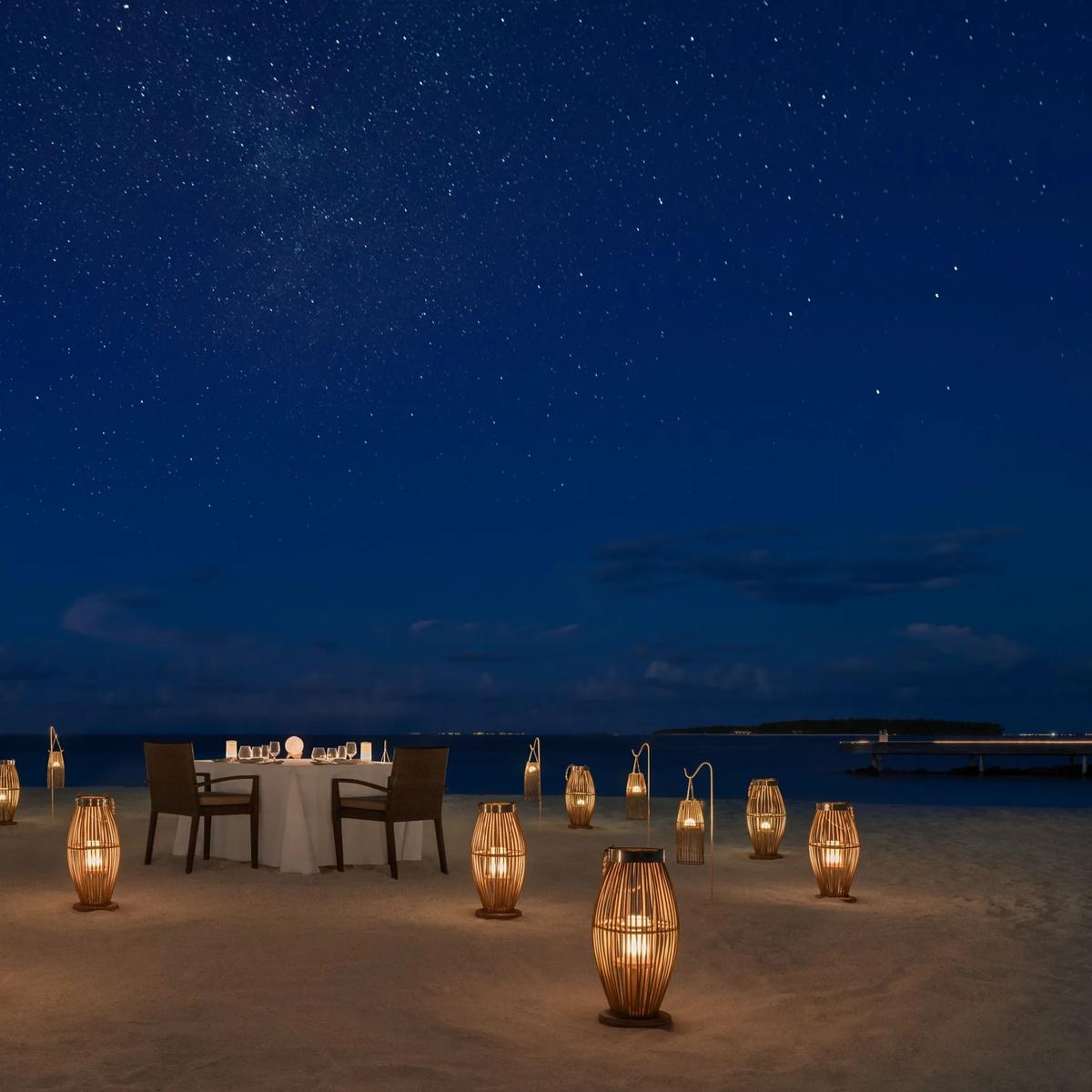 A private Starlight Dinner set up on the beach at The St. Regis Maldives Vommuli Resort