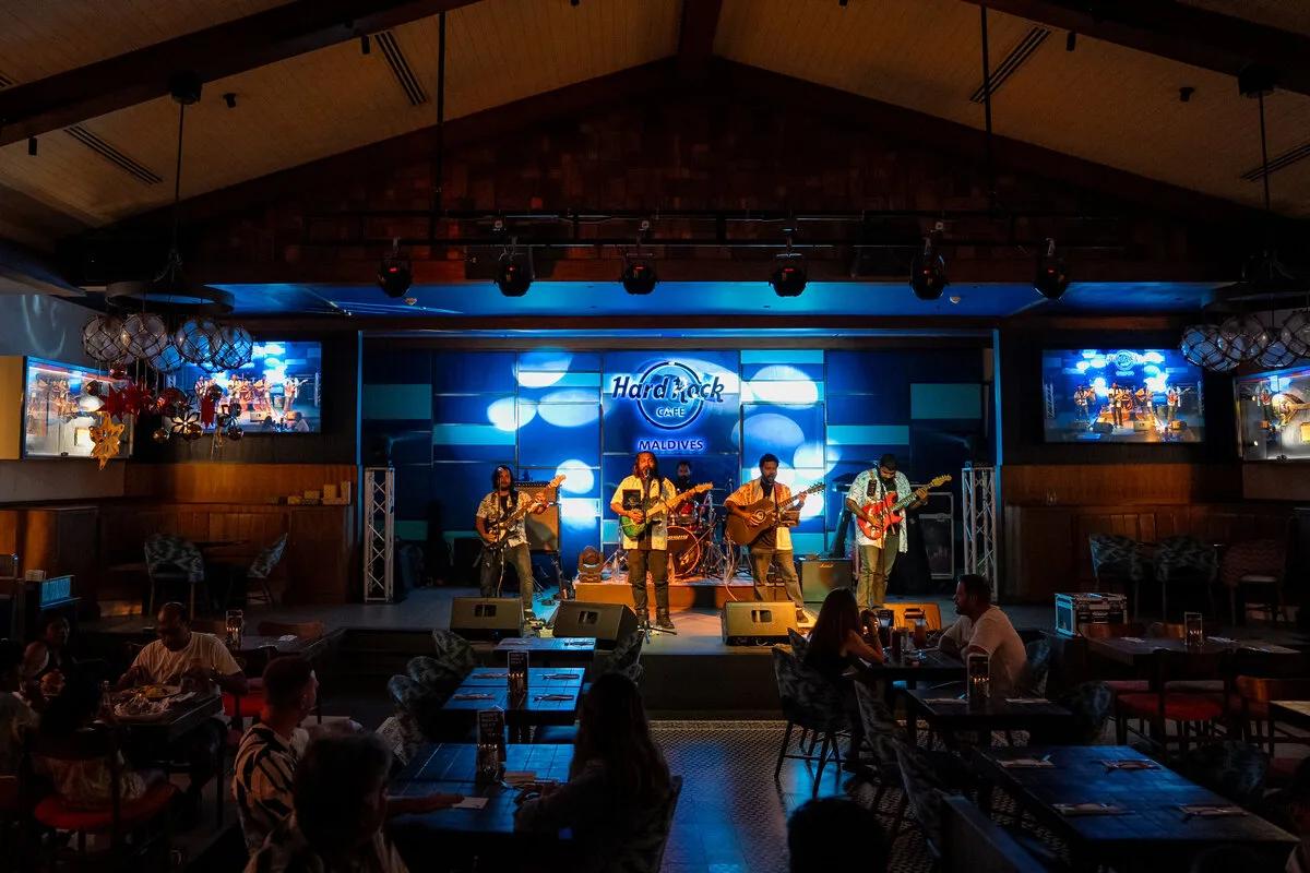A live band performs on stage at Hard Rock Cafe Maldives, part of the resort's regular entertainment residencies