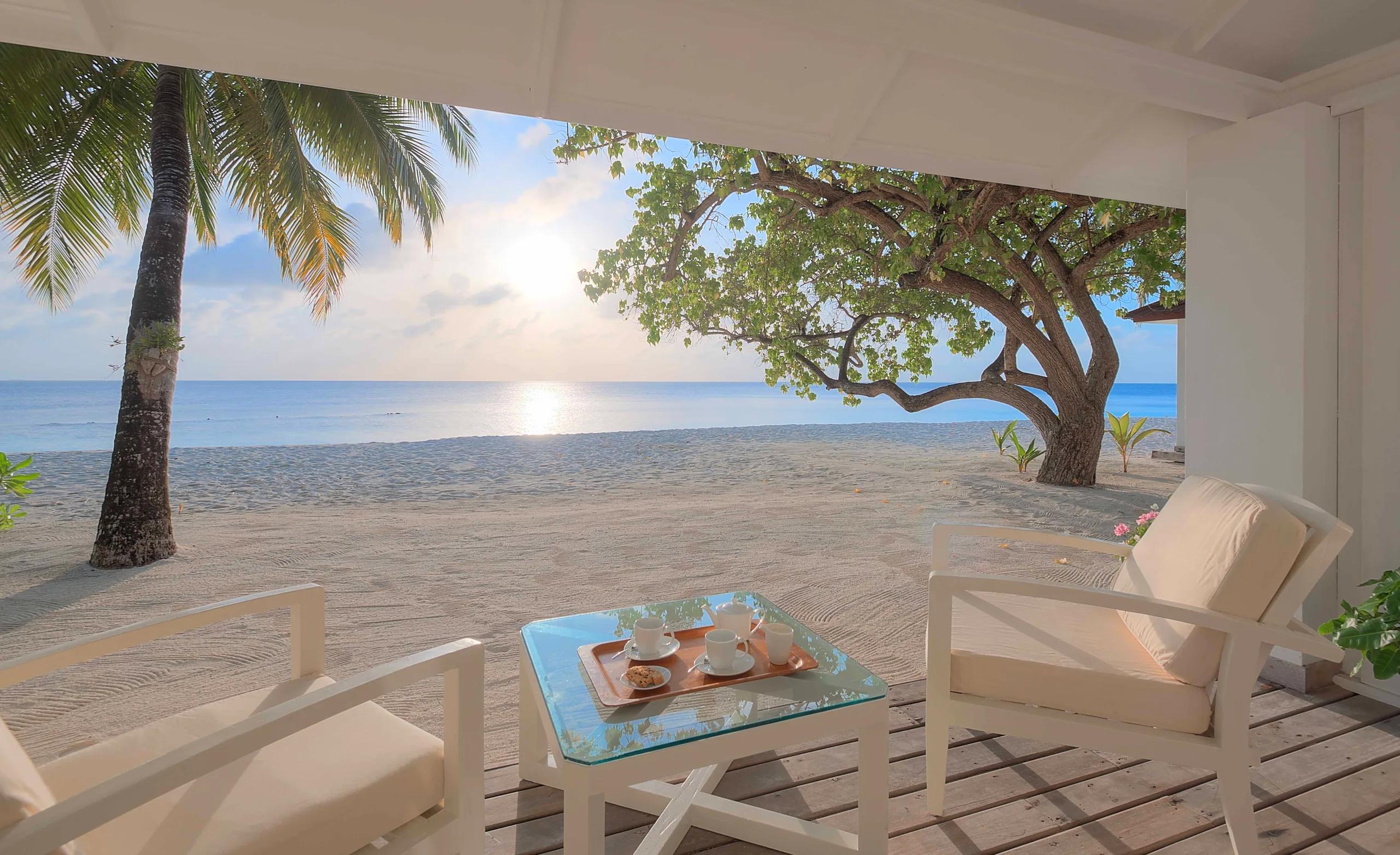 Sunrise light across a Beach Front Villa's private terrace, with tea laid out for two