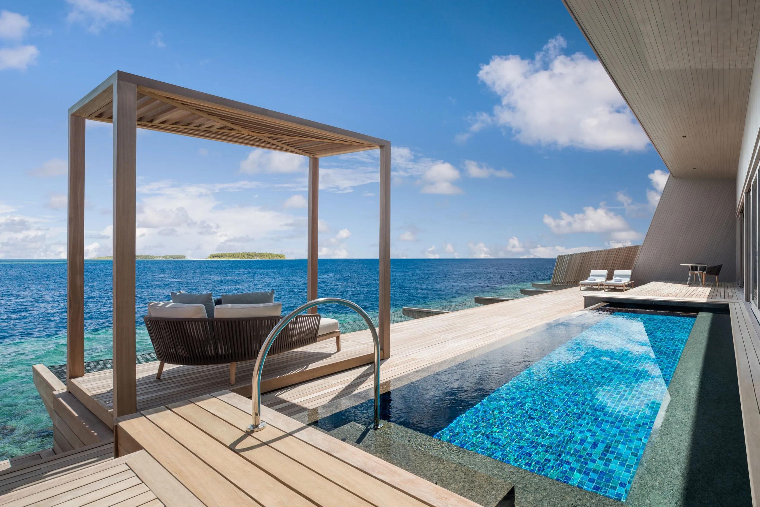 The exterior and terrace of an Overwater St. Regis Suite, with its private outdoor cabana