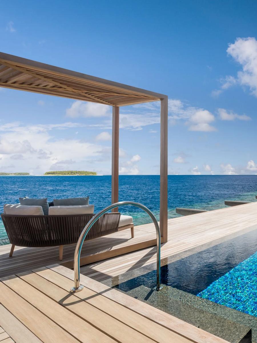 The exterior and terrace of an Overwater St. Regis Suite, with its private outdoor cabana