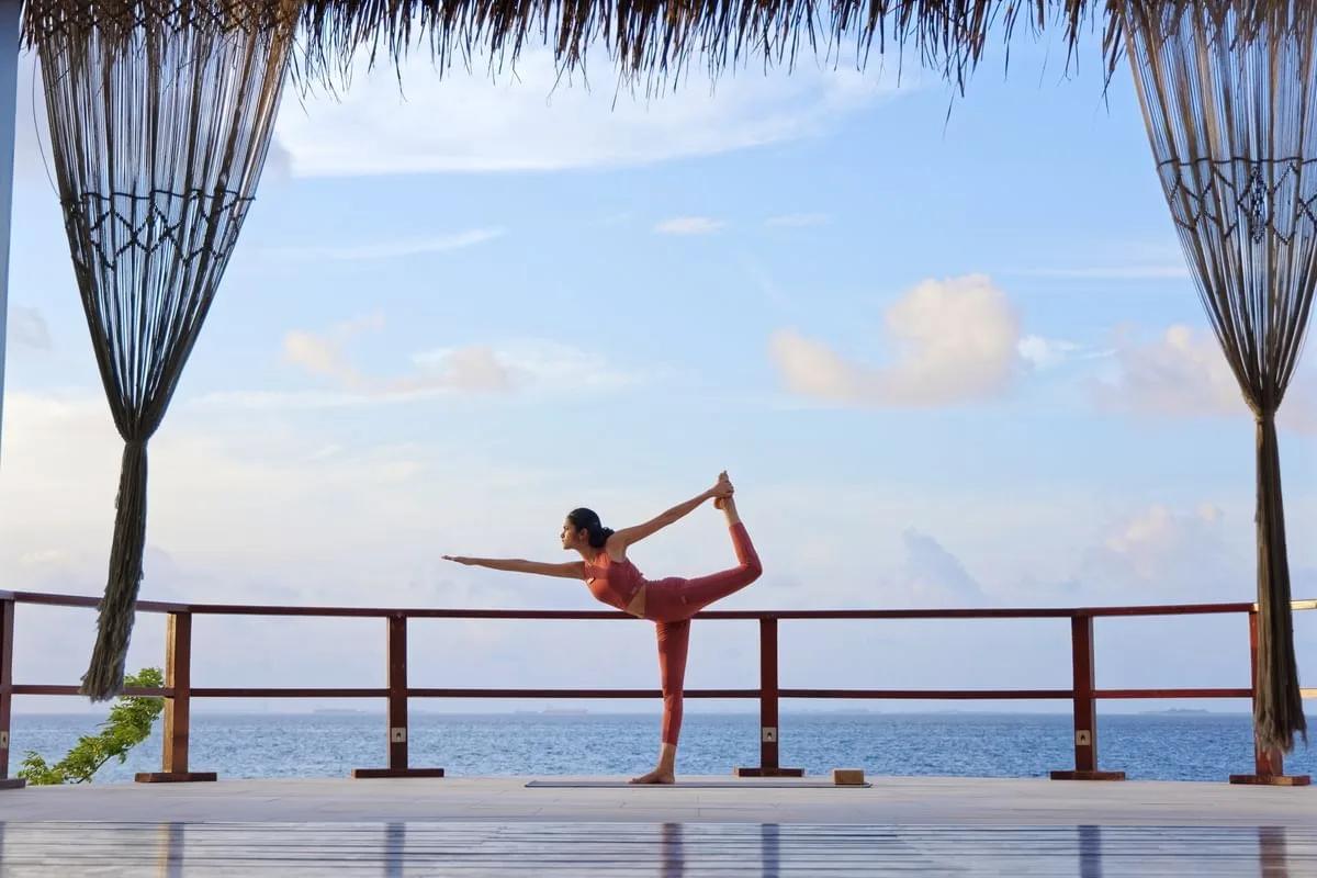 A morning yoga class at the resort's open-air, lagoon-facing Yoga & Meditation Deck