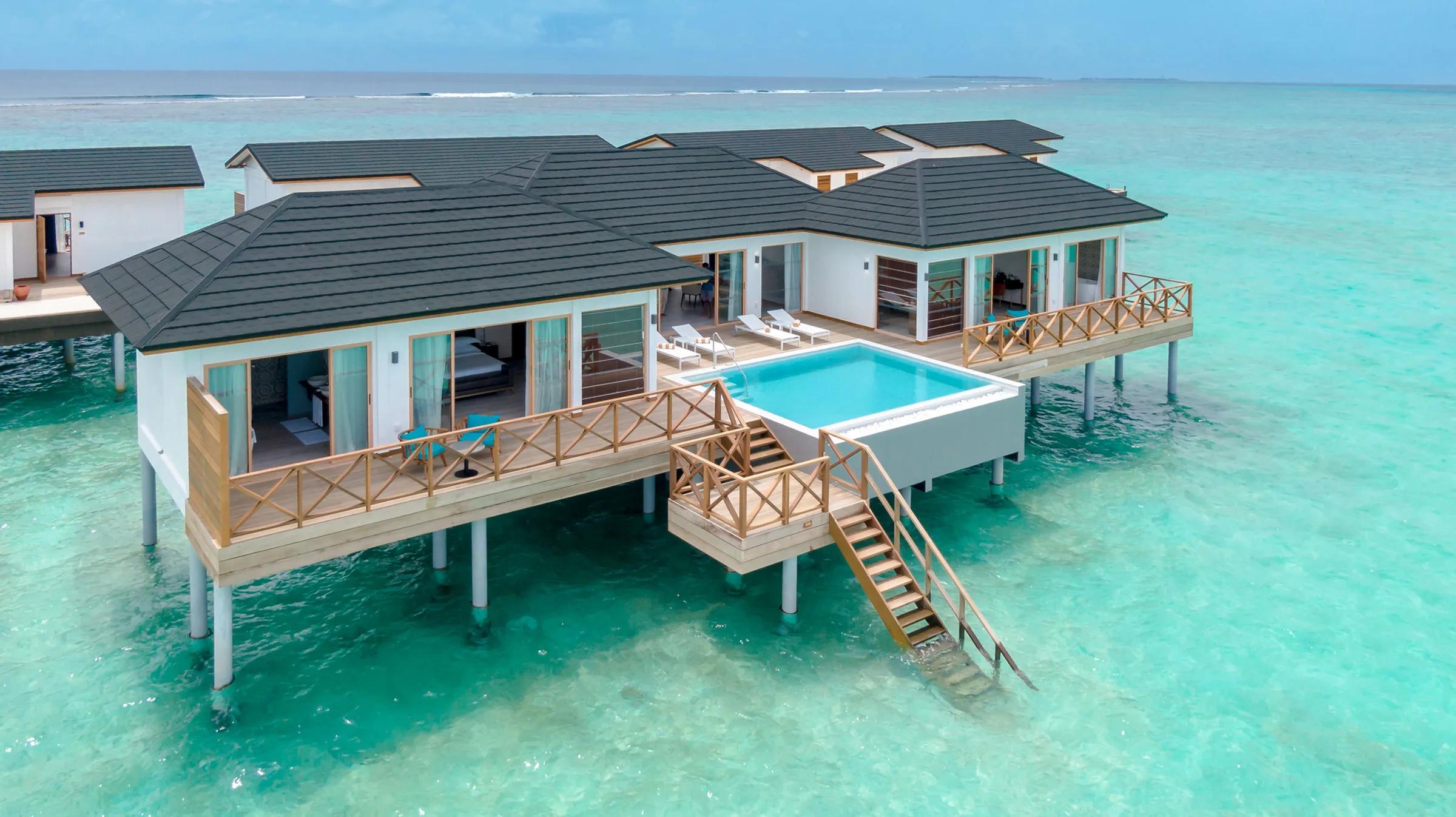 An aerial view of the Lagoon Residence's overwater structure, its private pool and deck built out over the lagoon