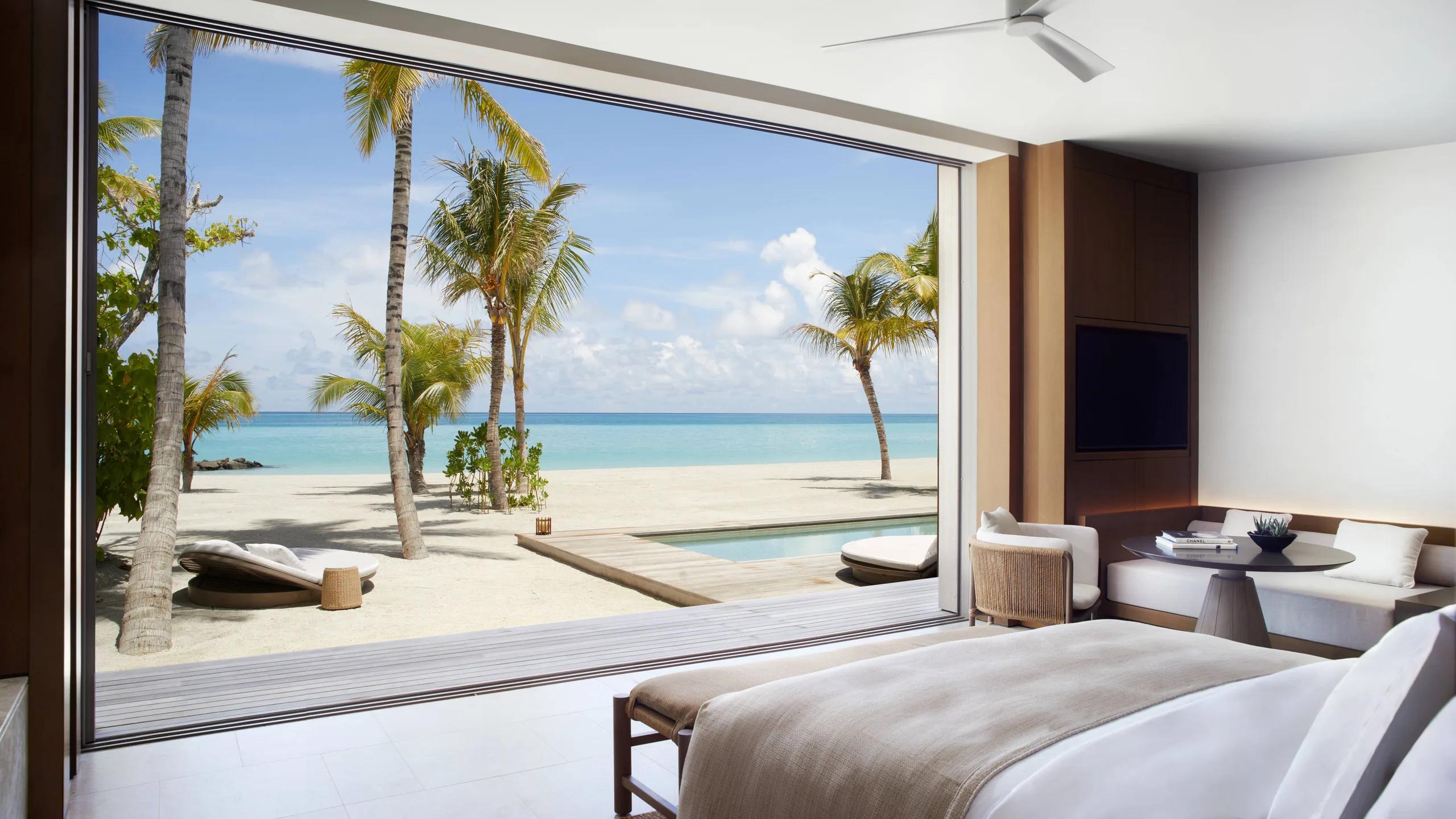 A Beach Pool Villa bedroom stepping straight onto the beach and pool deck