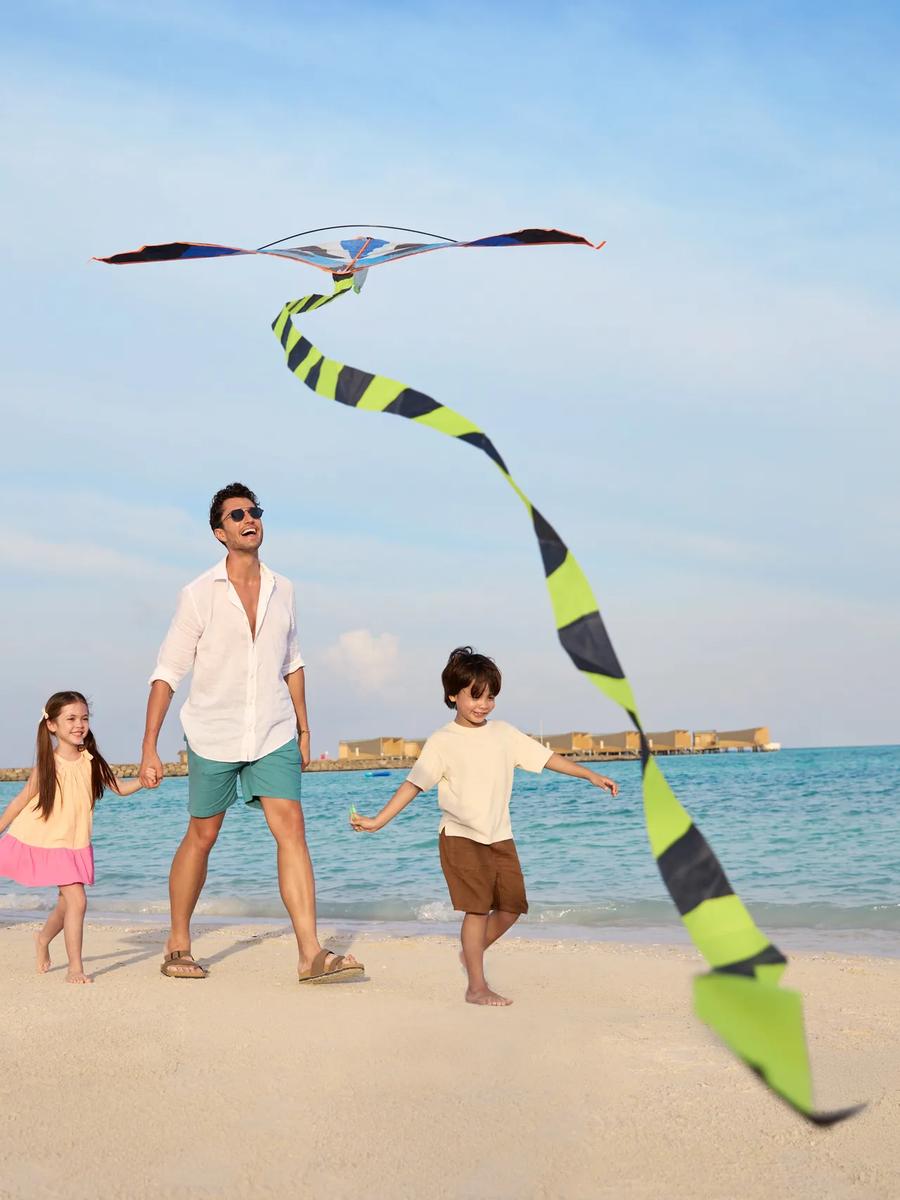 A family on the beach at Centara Mirage Lagoon Maldives (no dedicated Four Bedroom Beach House photo was available in the research pool)