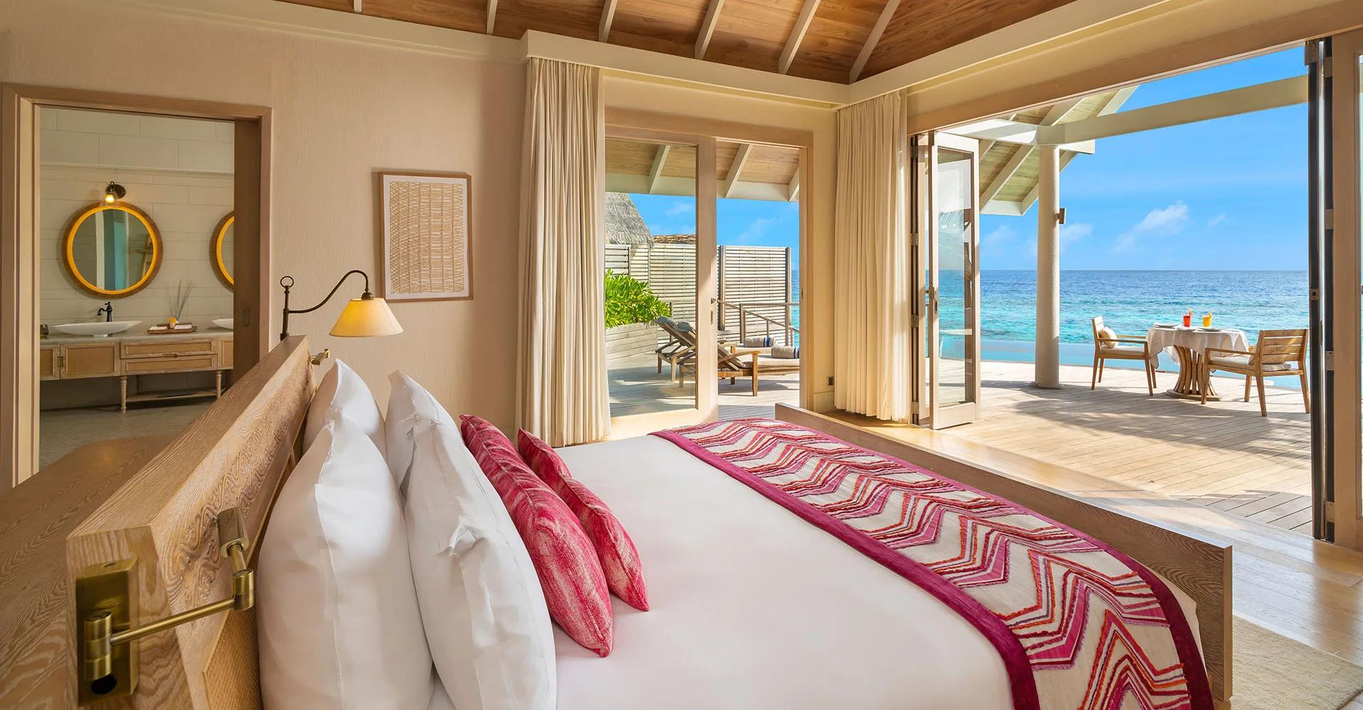 Interior of a Water Pool Villa at Milaidhoo, with the bed facing the lagoon.
