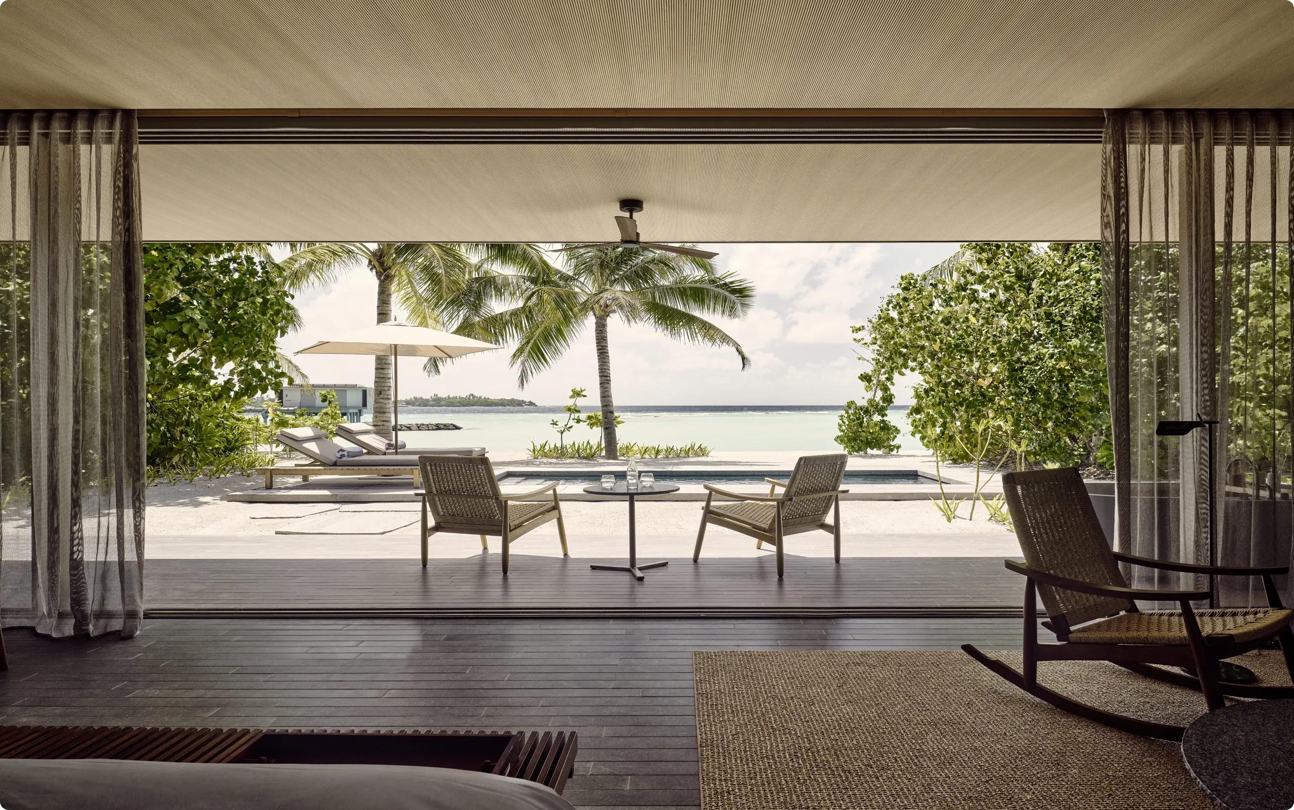 A private pool deck at a One-Bedroom Beach Pool Villa, an overwater villa visible across the lagoon