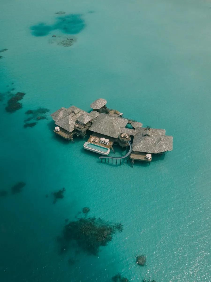 Aerial view of a Two-Bedroom Overwater Sea Loft and the surrounding lagoon at Soneva Secret