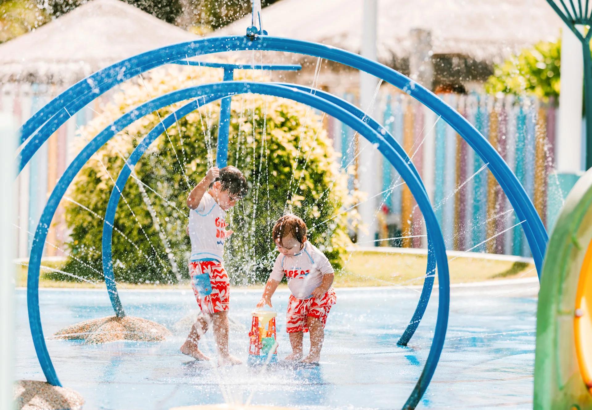 Children playing in the mini splash park beside Krakegiri Kids Club